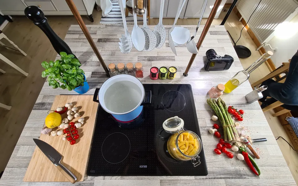Kitchen island prepared with ingredients, Just Spices seasonings and a camera