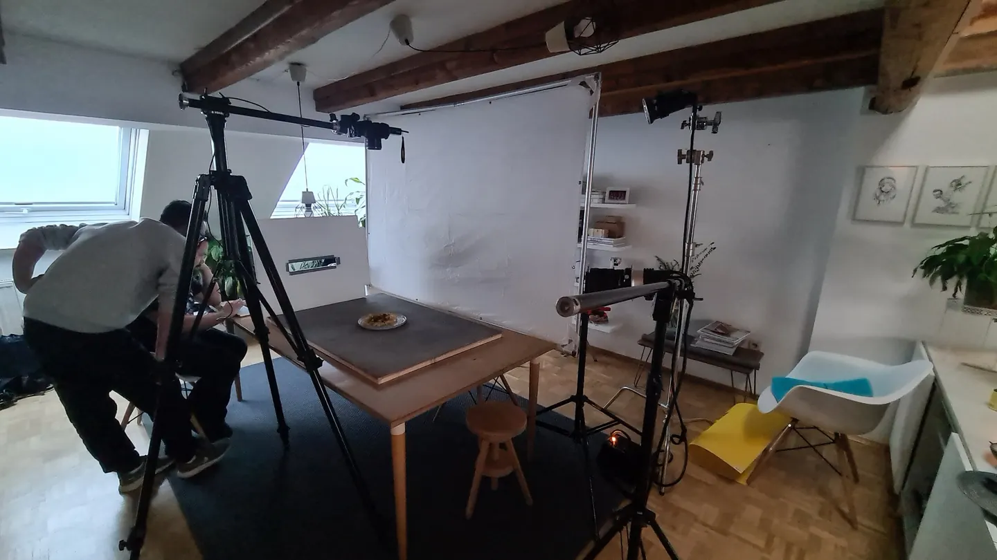 The team at the food set, surrounded by the camera tripod, diffuser and lighting